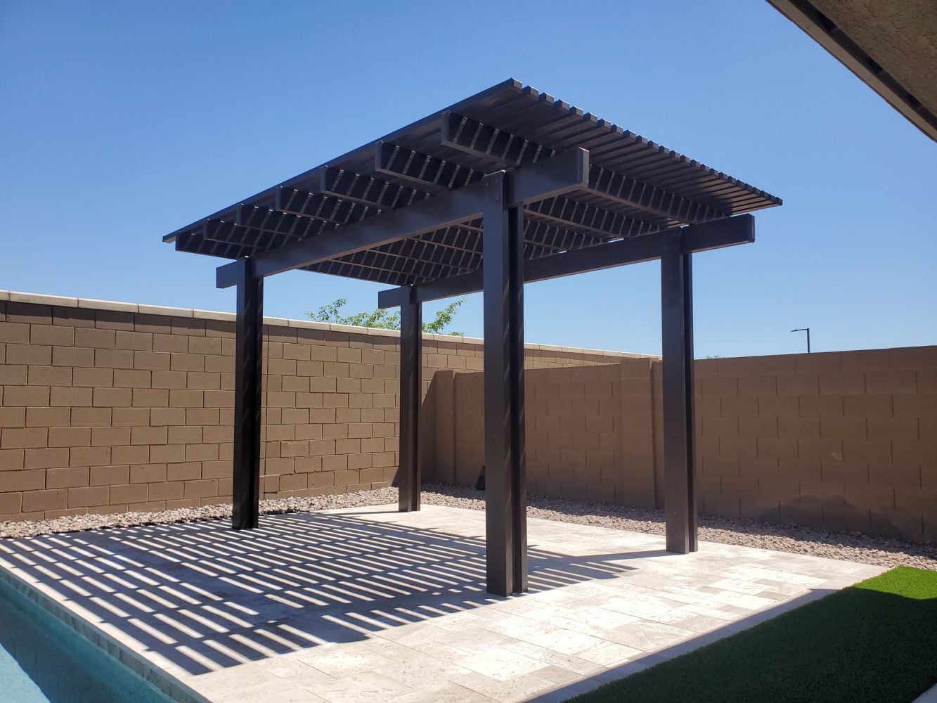 Litchfield Park oasis featuring a stylish lattice cover, creating a serene outdoor living area with Southwest Patio.