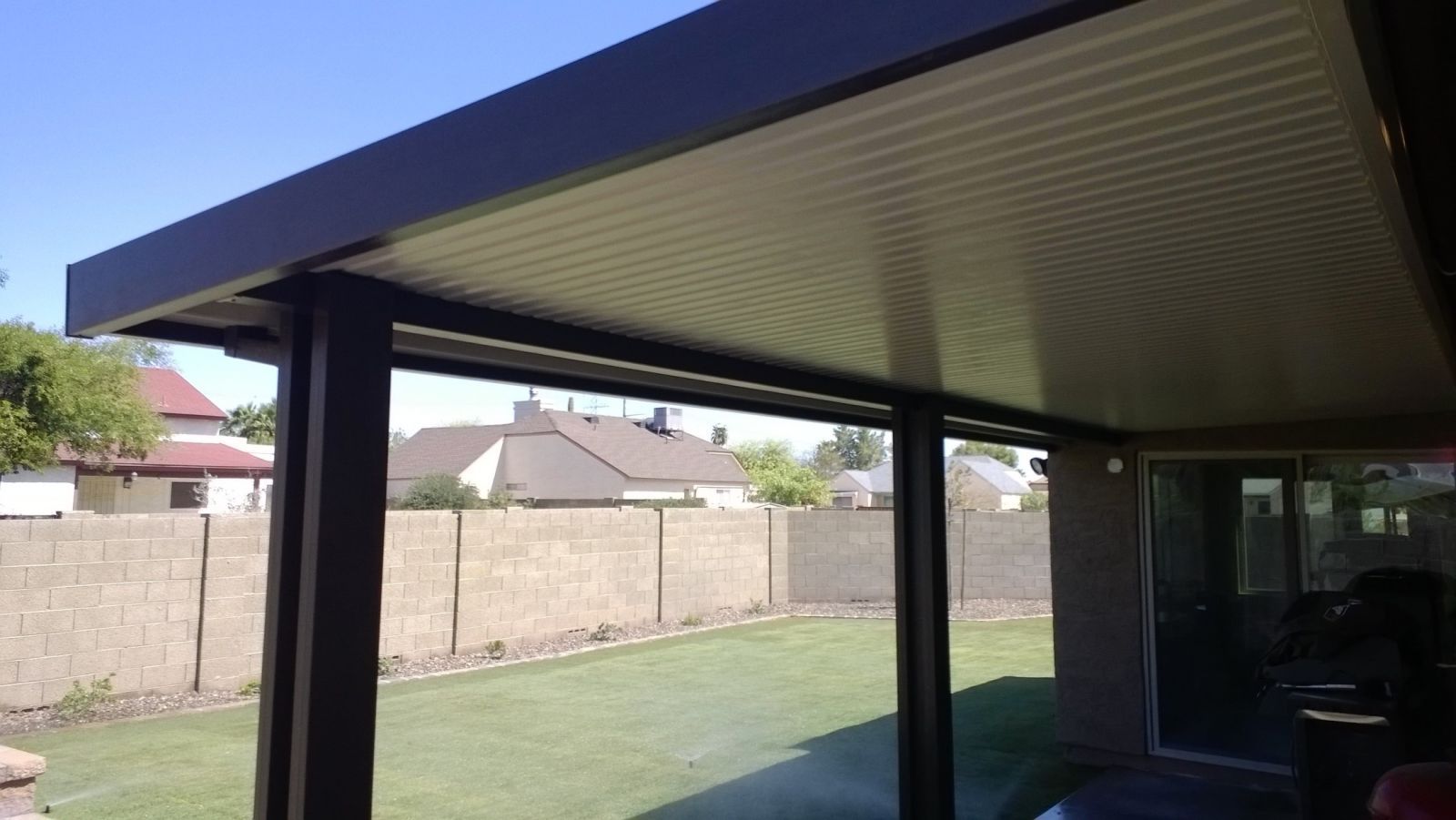 Surprise backyards revitalized with stylish Flat Pan Patio Covers, offering a cool retreat from the heat.