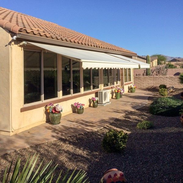 Spacious outdoor entertainment area in Gilbert, AZ, shaded by a Southwest Patio gabled roof cover.