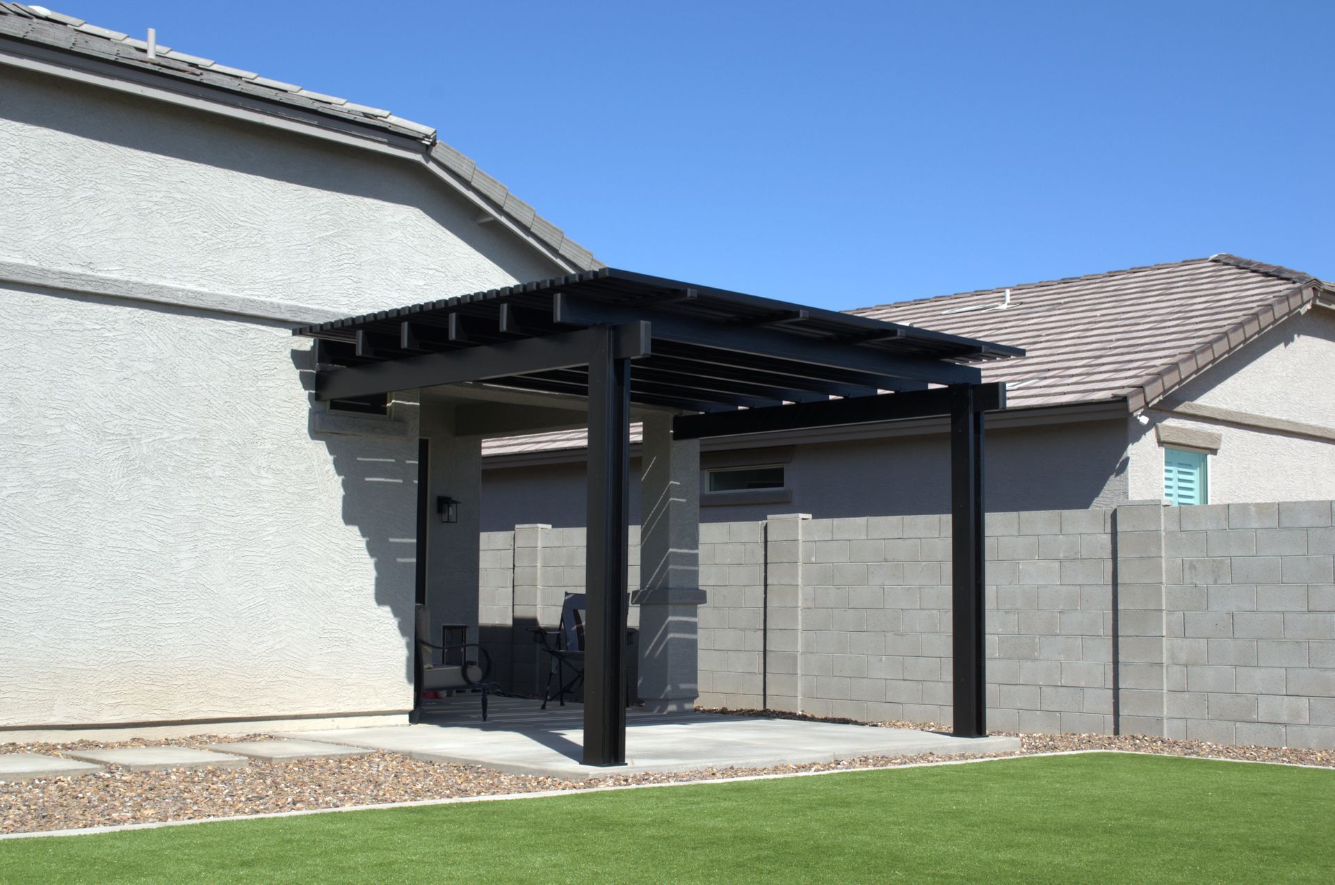 Customized aluminumwood patio covers installed in a Peoria backyard.