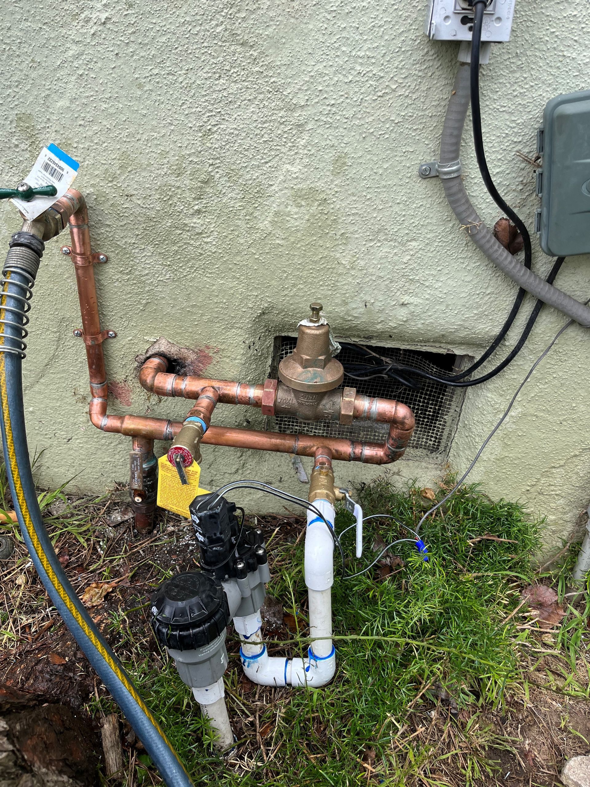 PVC and copper pipes in a wood-framed basement