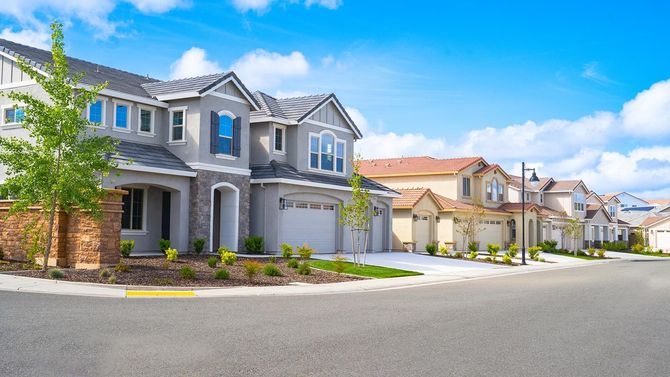 Row of houses on a sunny street with blue sky Row of houses on a sunny street with blue sky