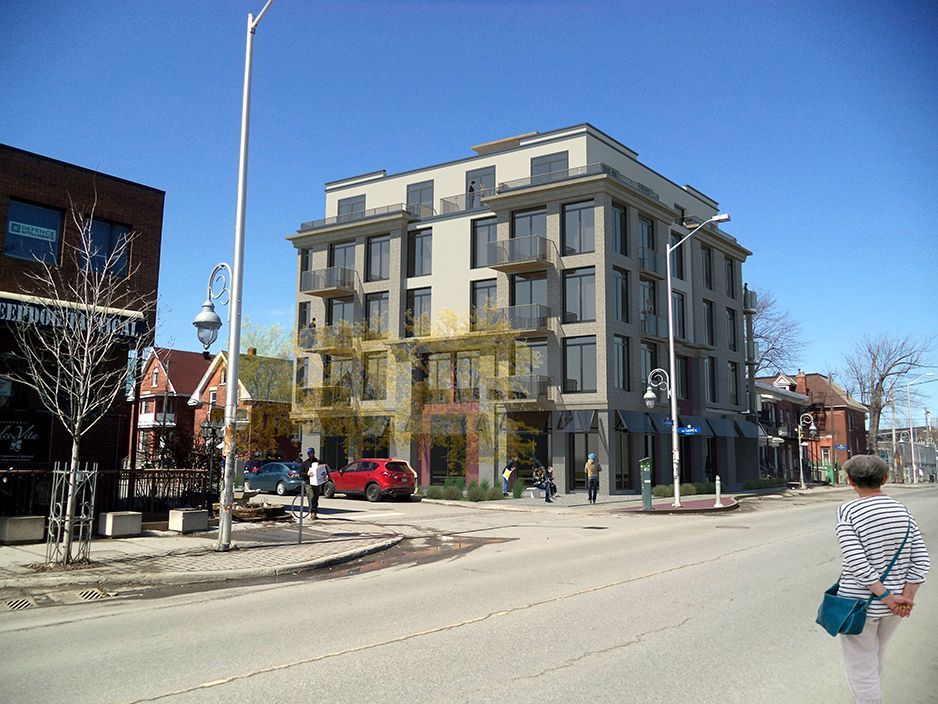 A woman is walking down the street in front of a large building.
