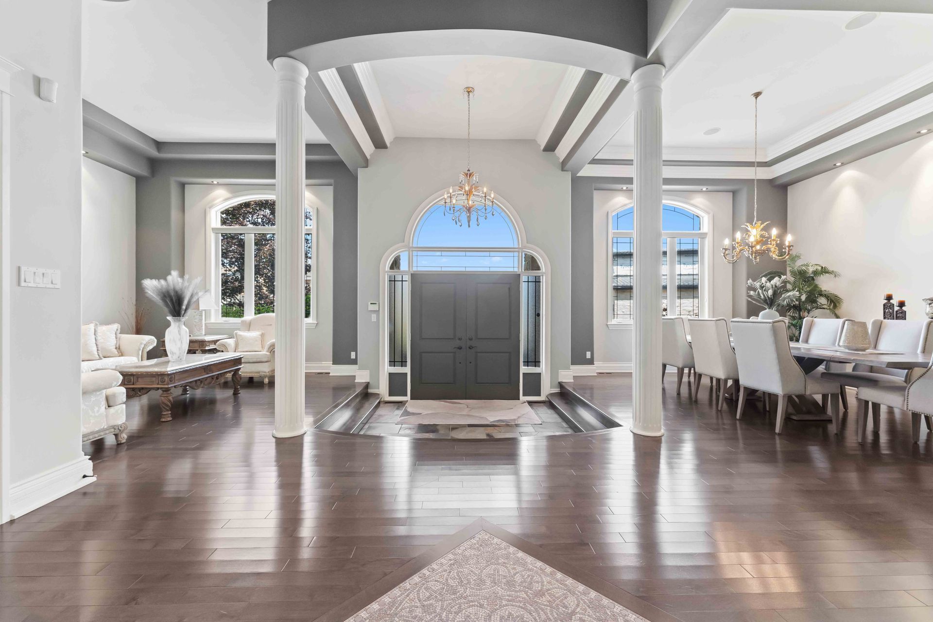 A large living room with hardwood floors and a dining room.