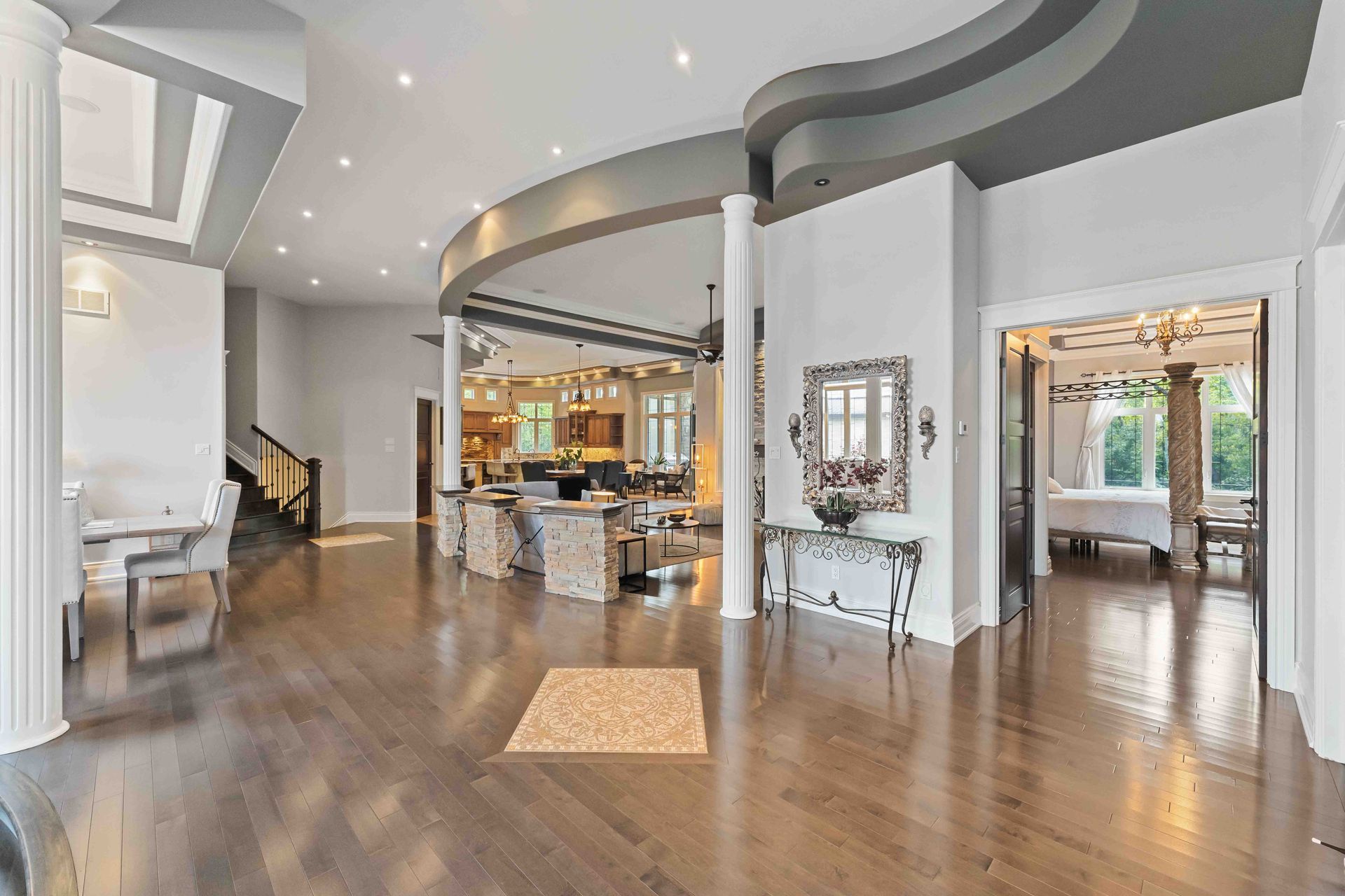 A large living room with hardwood floors and a curved ceiling.