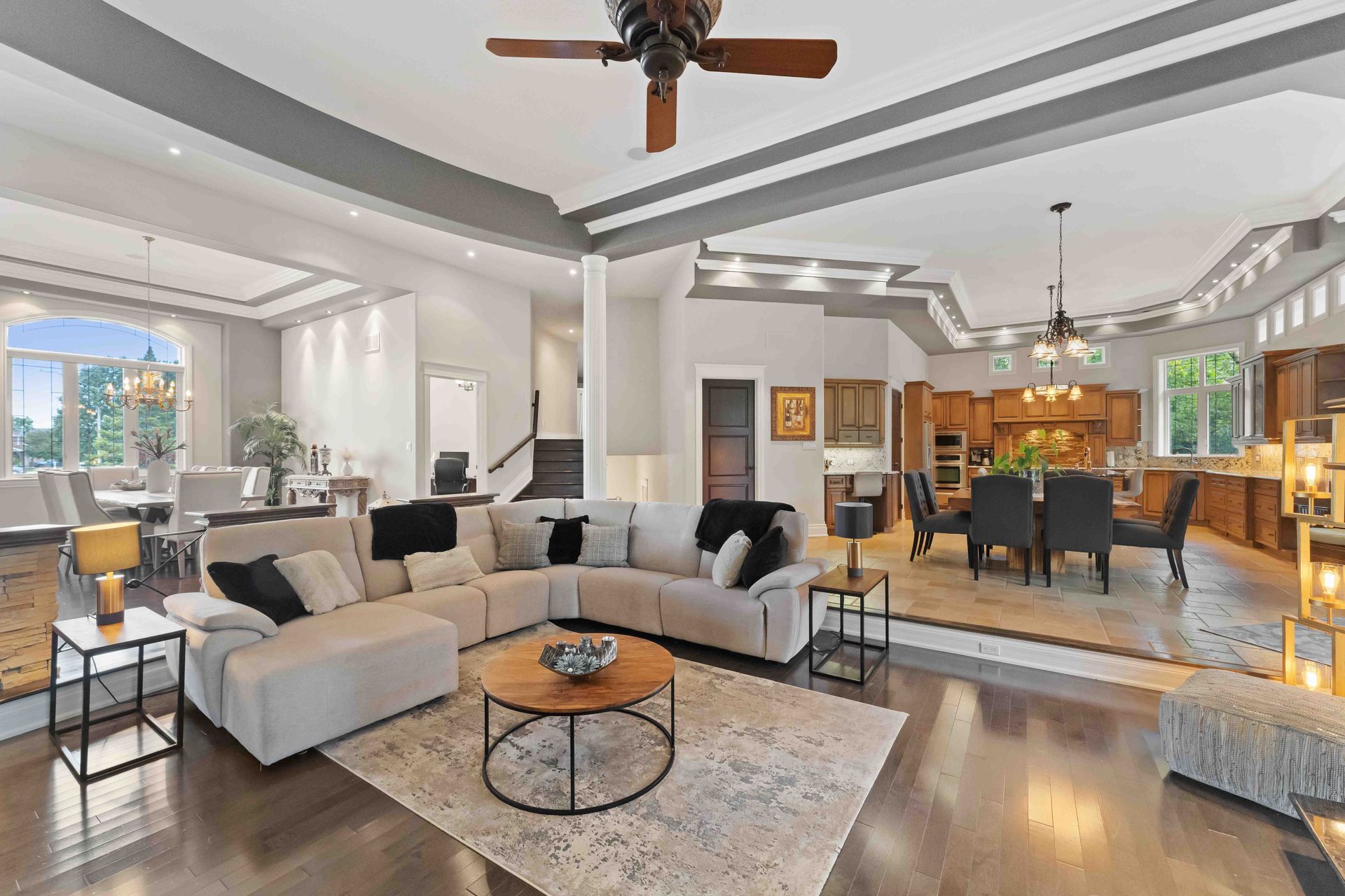 A living room filled with furniture and a ceiling fan.