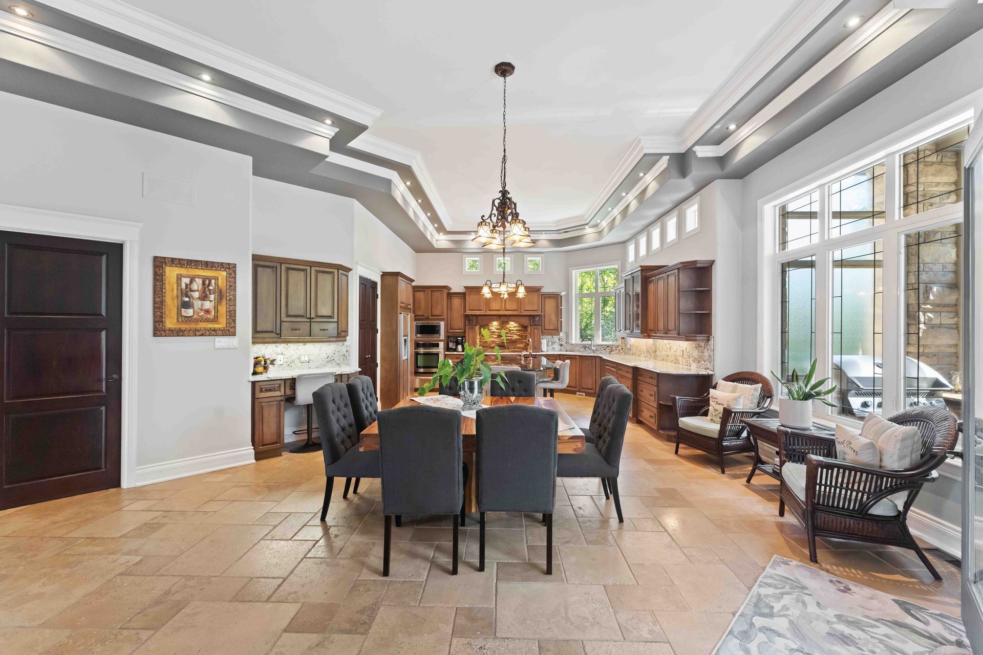 A large dining room with a table and chairs and a kitchen.