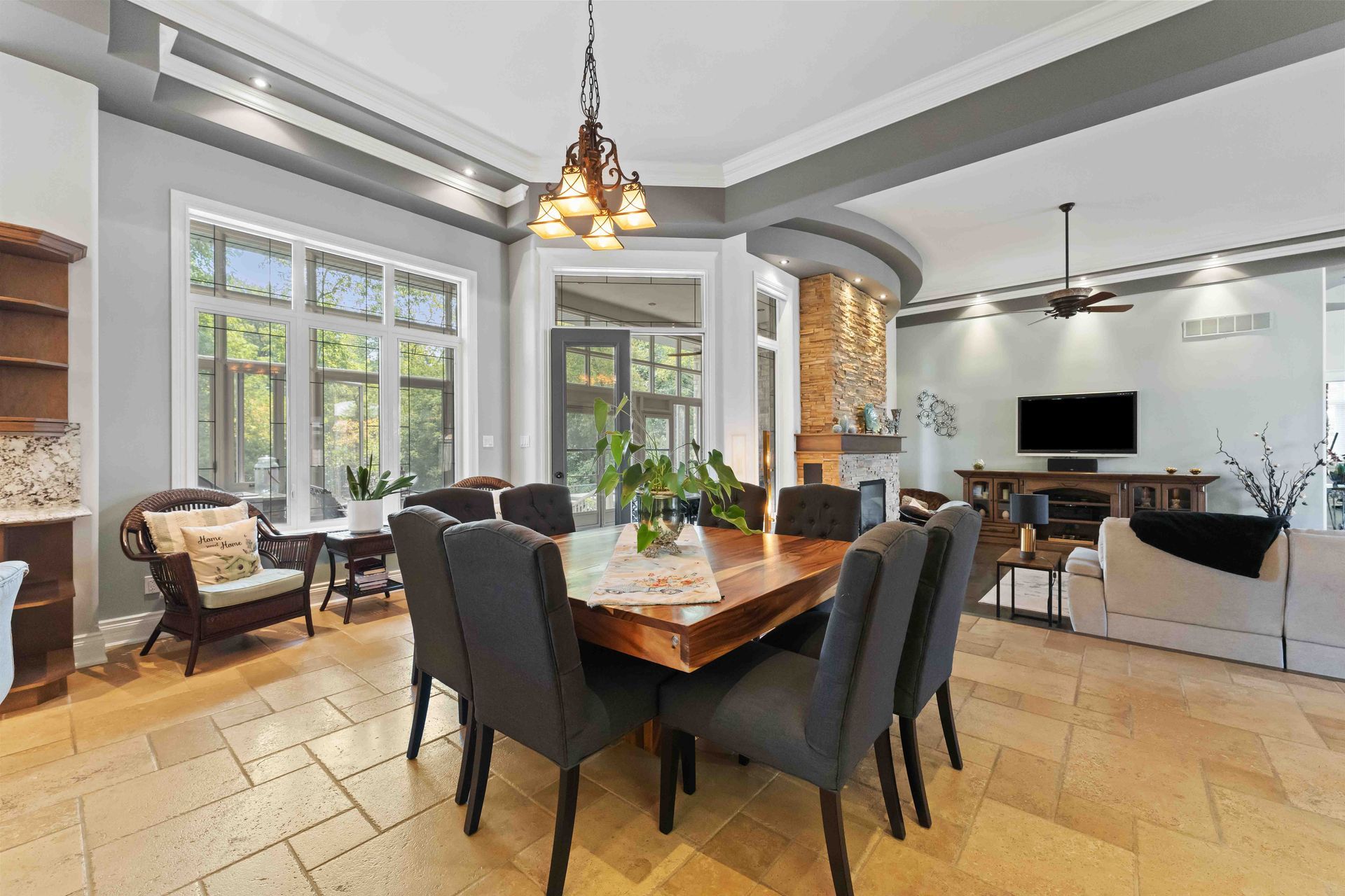 A large dining room with a wooden table and chairs.