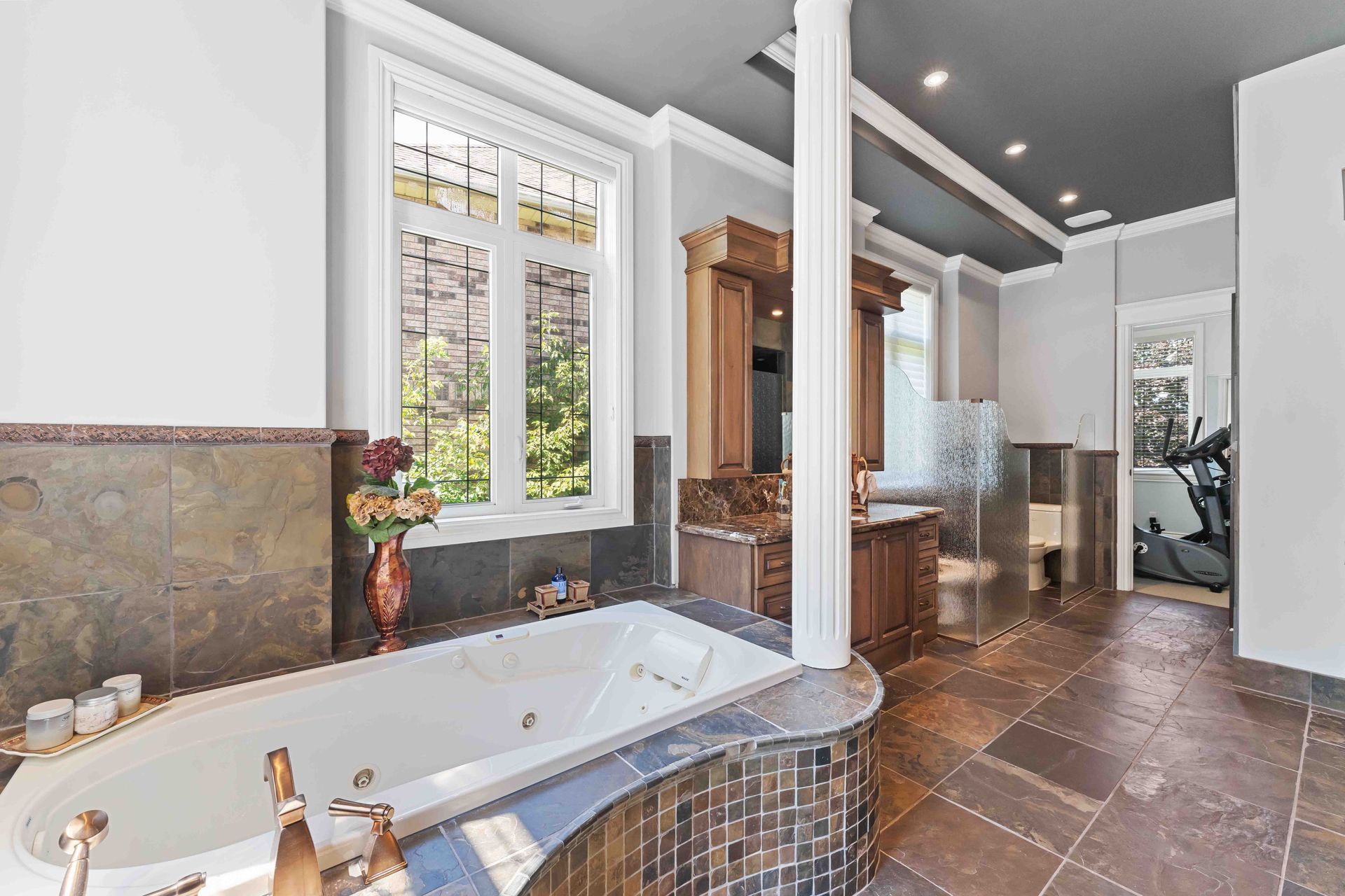 There is a large bathtub in the middle of the bathroom.