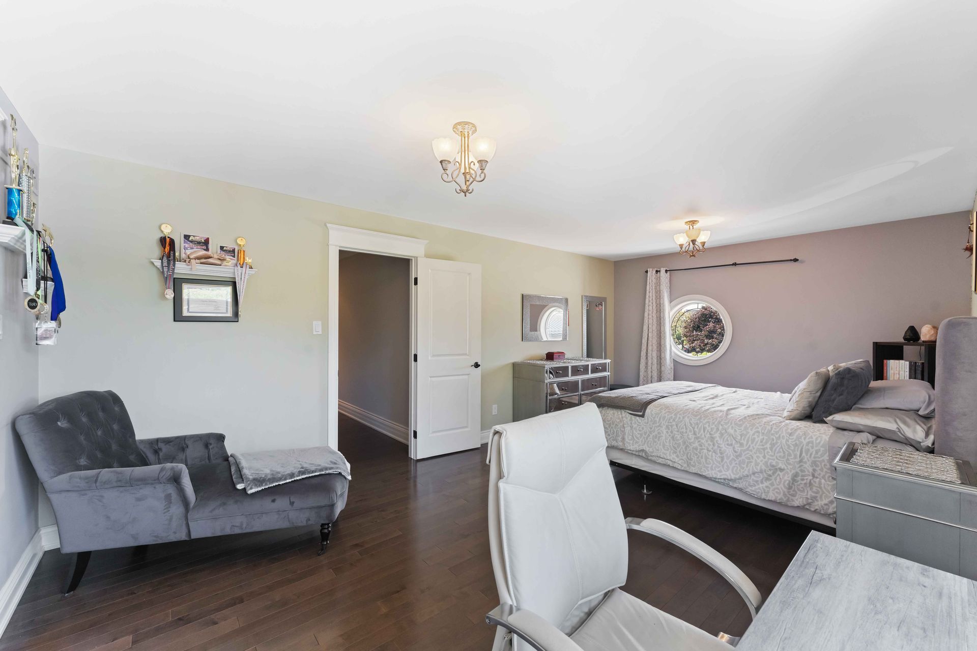 A bedroom with two beds , a desk and a chair.