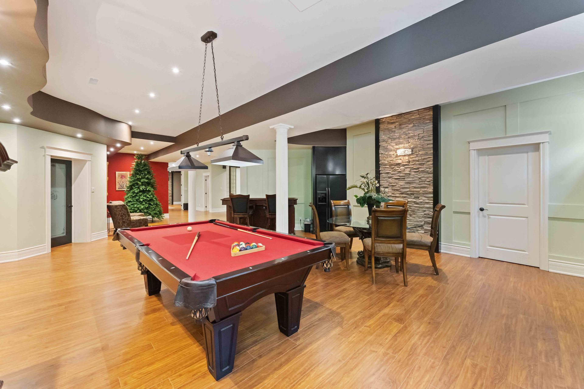 There is a pool table in the middle of the room.