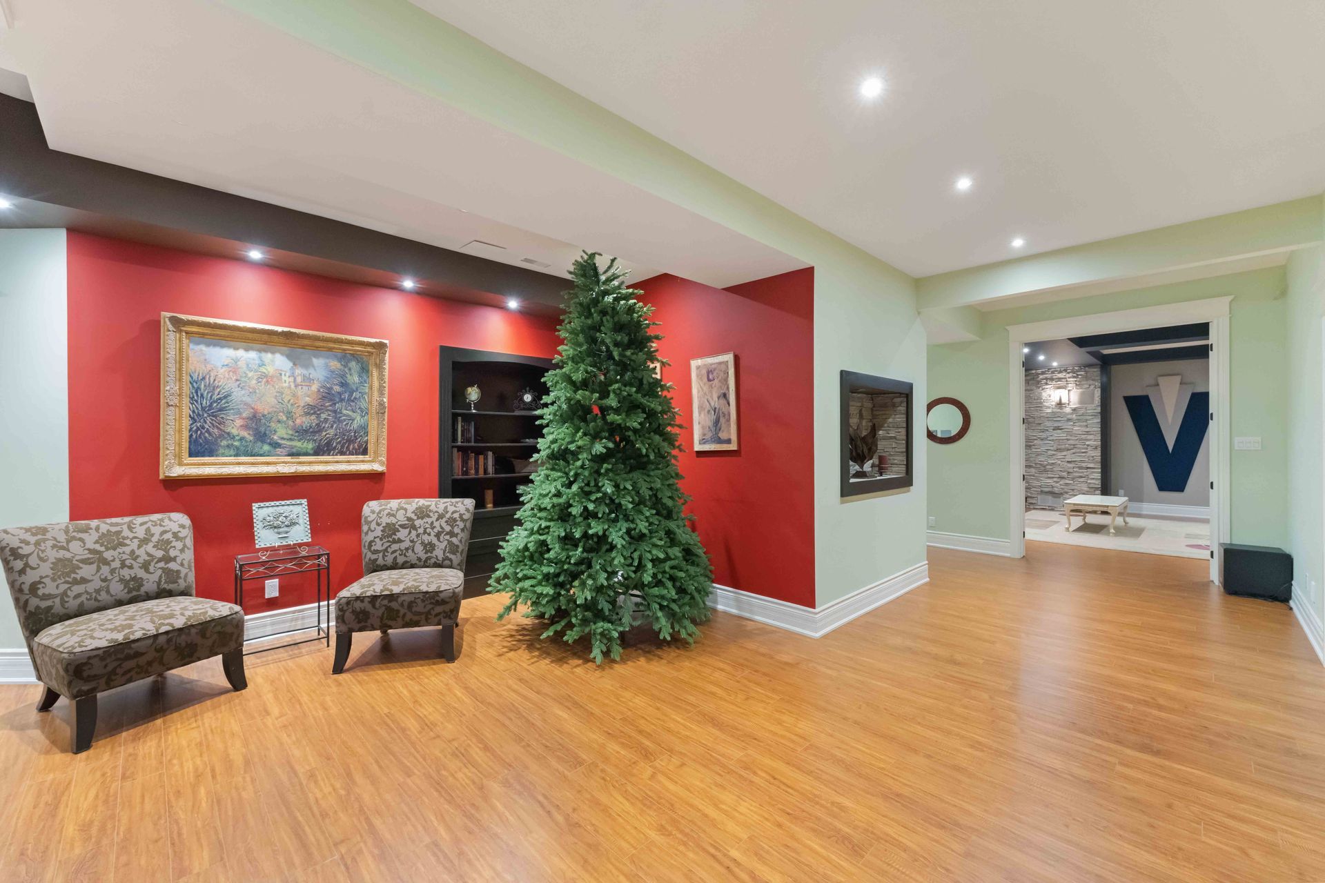 There is a christmas tree in the middle of the room.