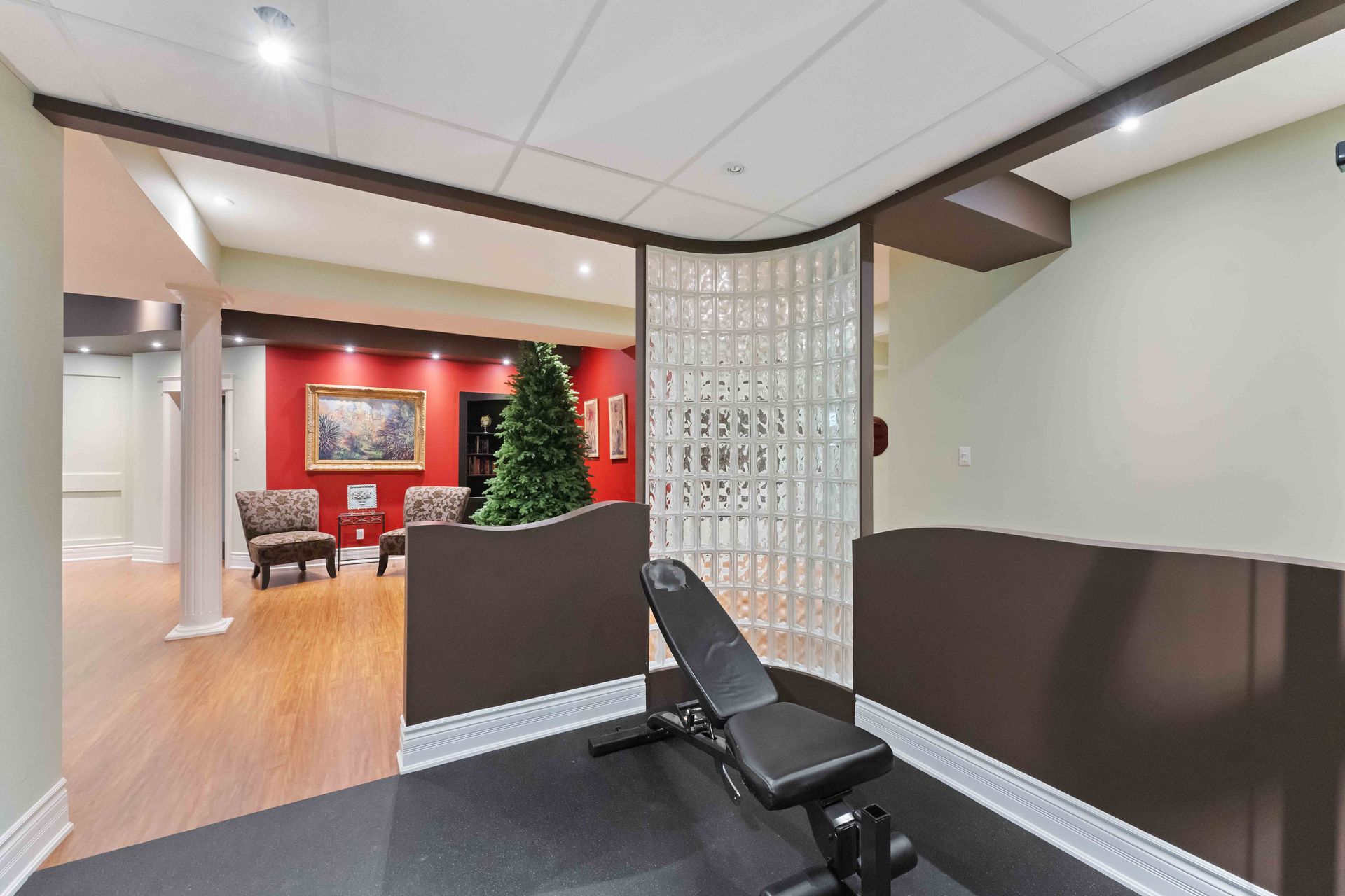 A gym with a bench and a christmas tree in the background