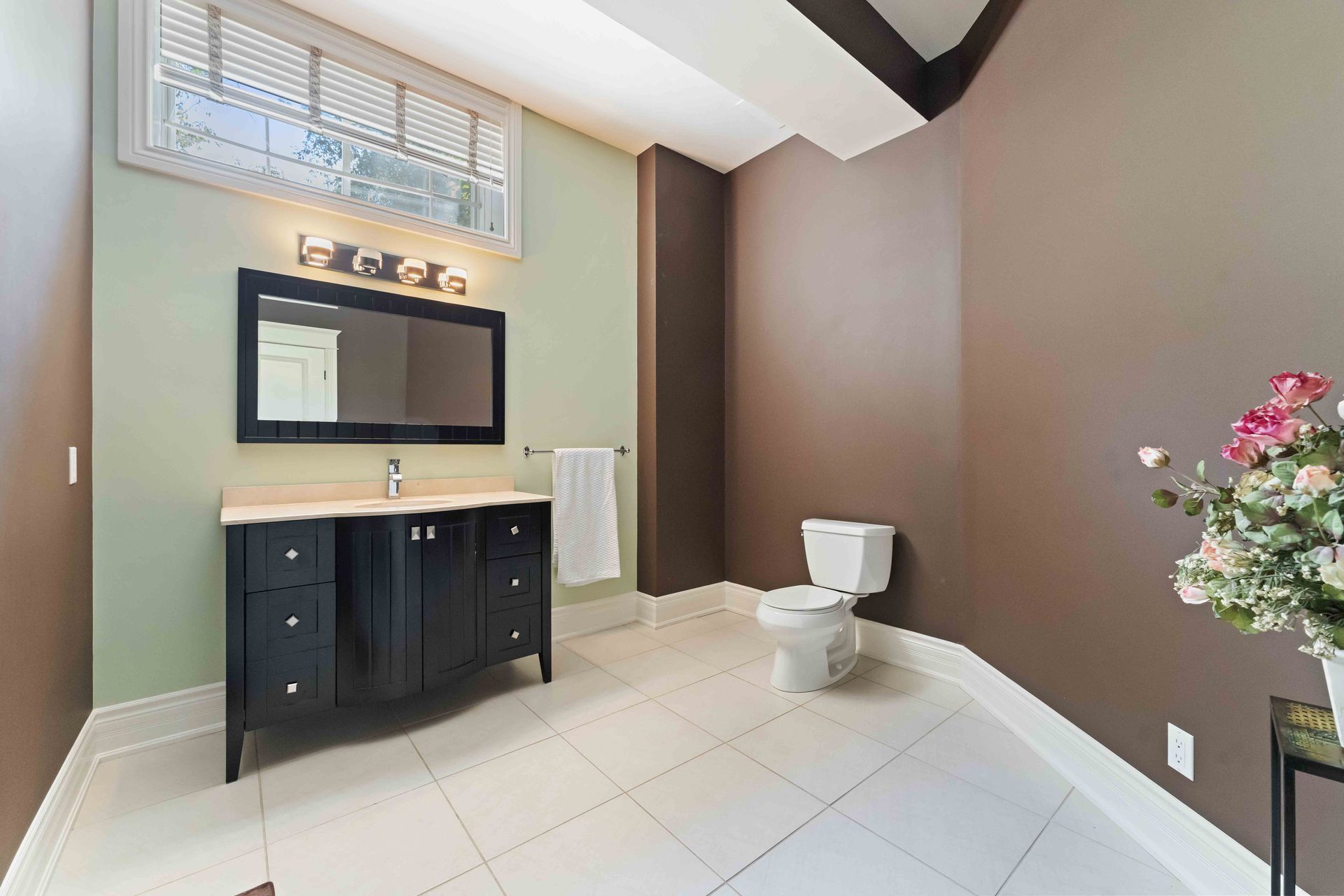A bathroom with a sink , toilet and mirror.