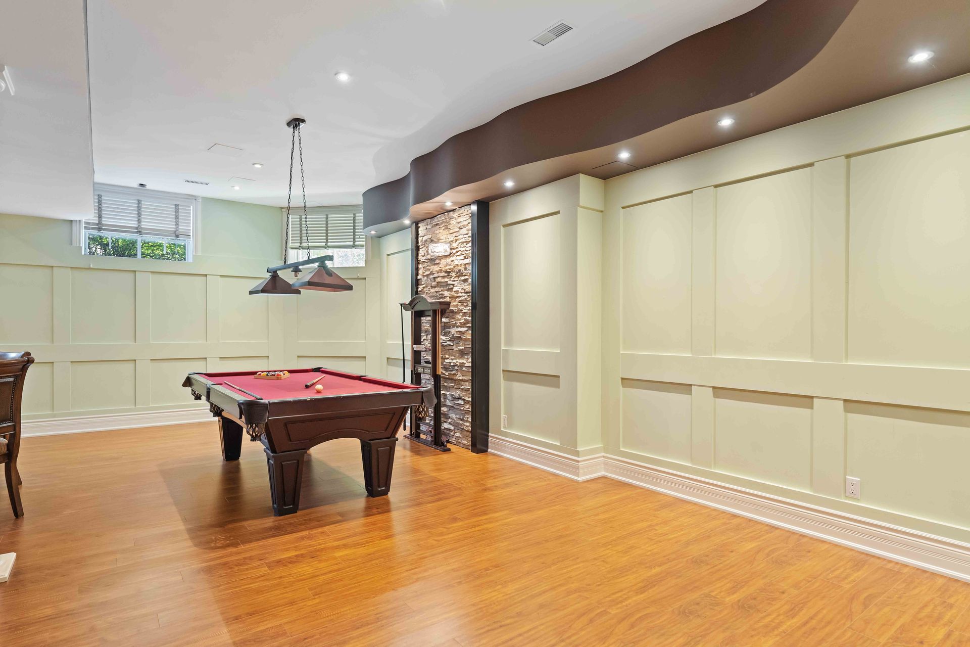 There is a pool table in the middle of the room.
