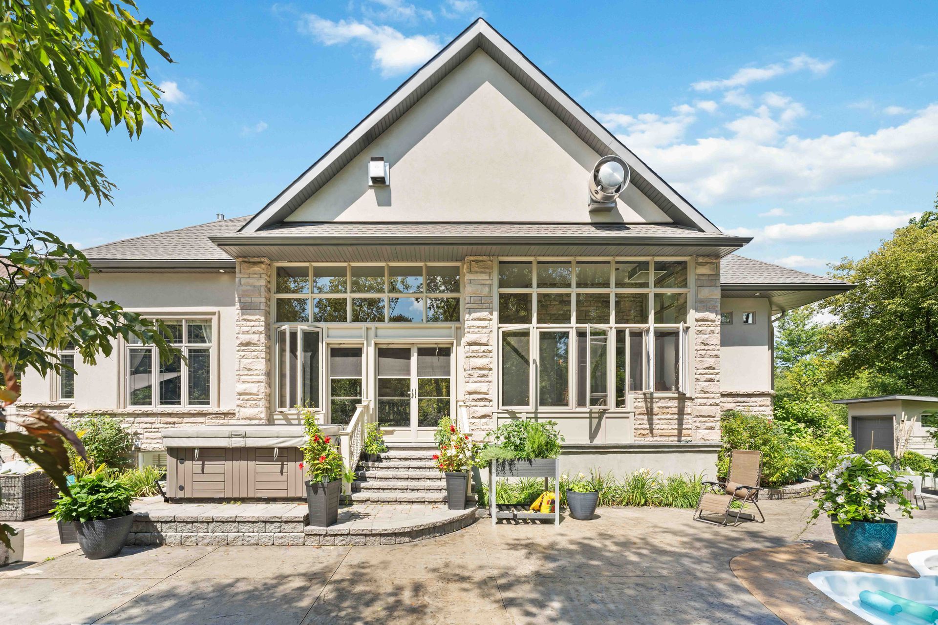 A large house with a lot of windows and a pool in the backyard