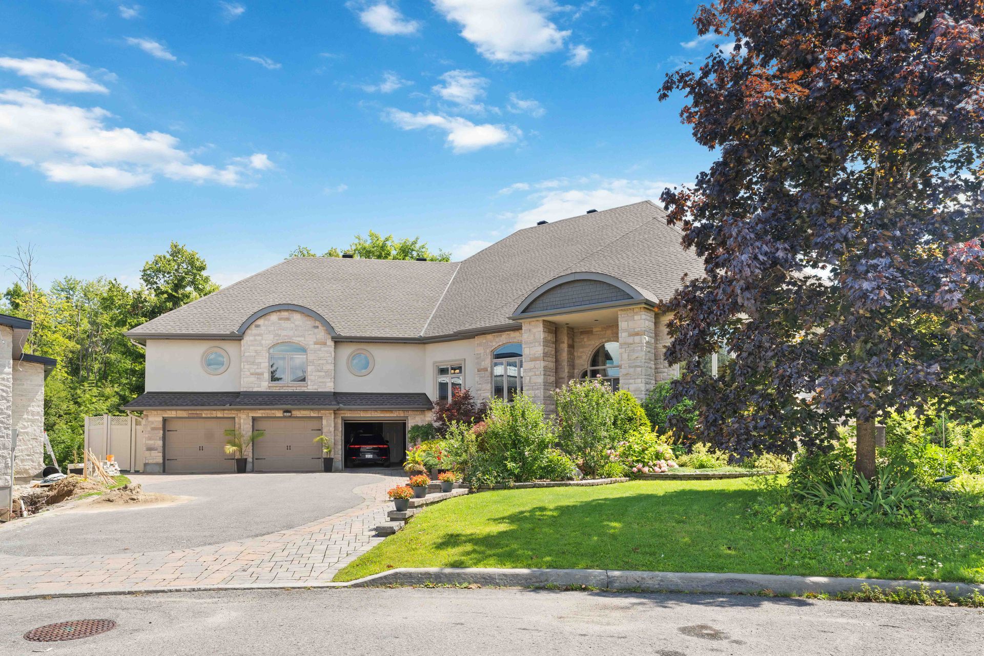 A large house with a car parked in front of it.