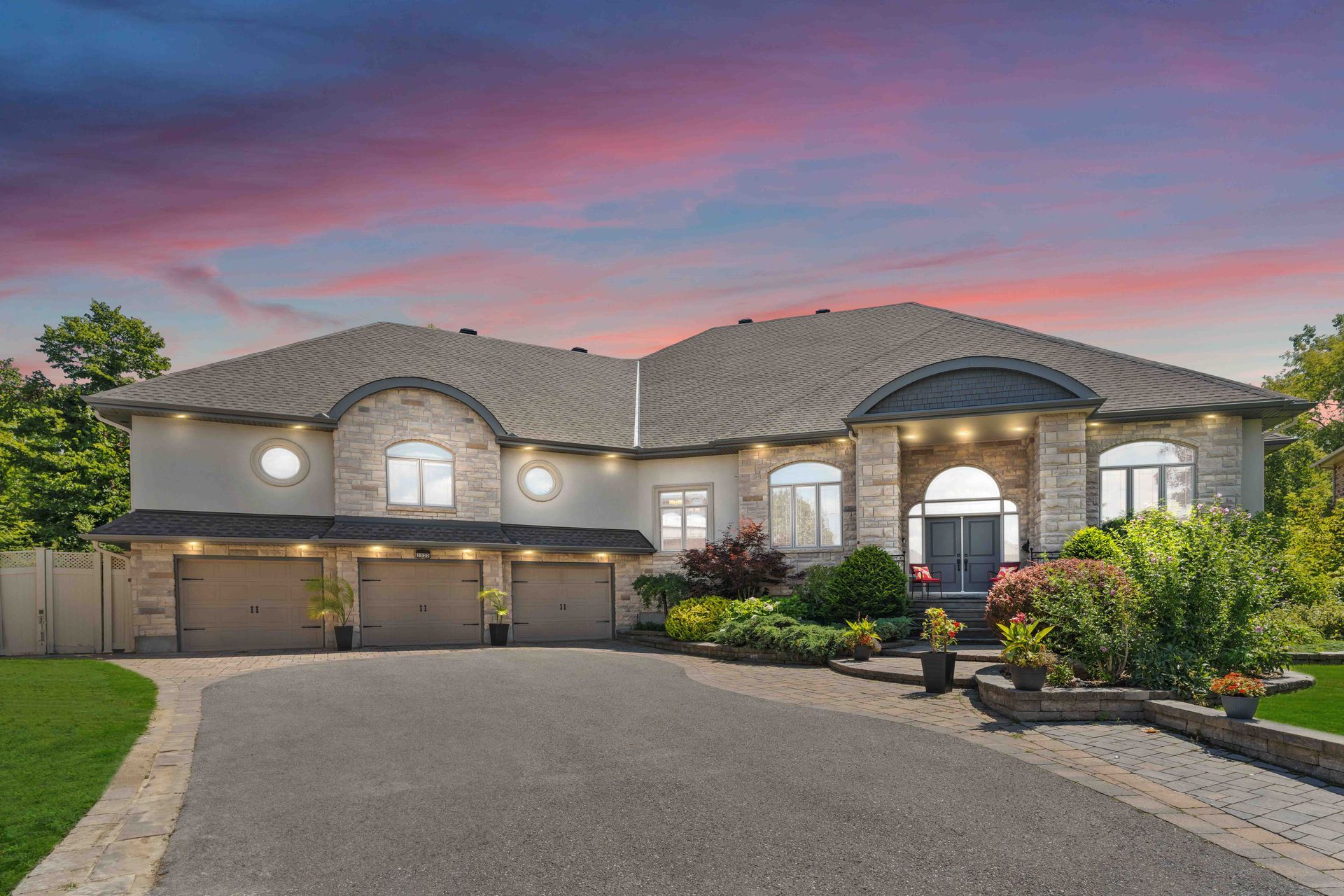 A large house with a driveway leading to it is for sale.