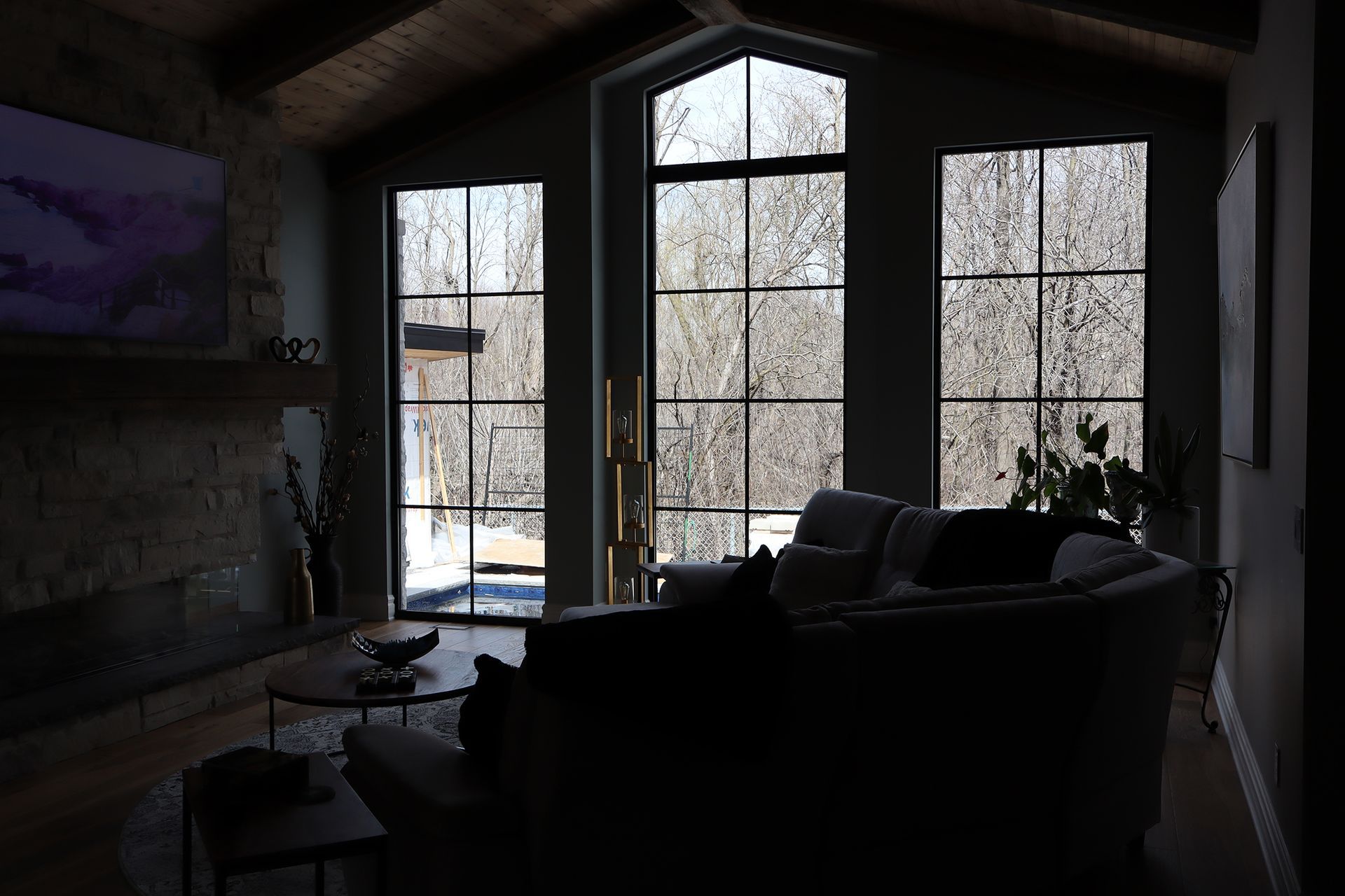 A living room with a lot of windows and a couch.