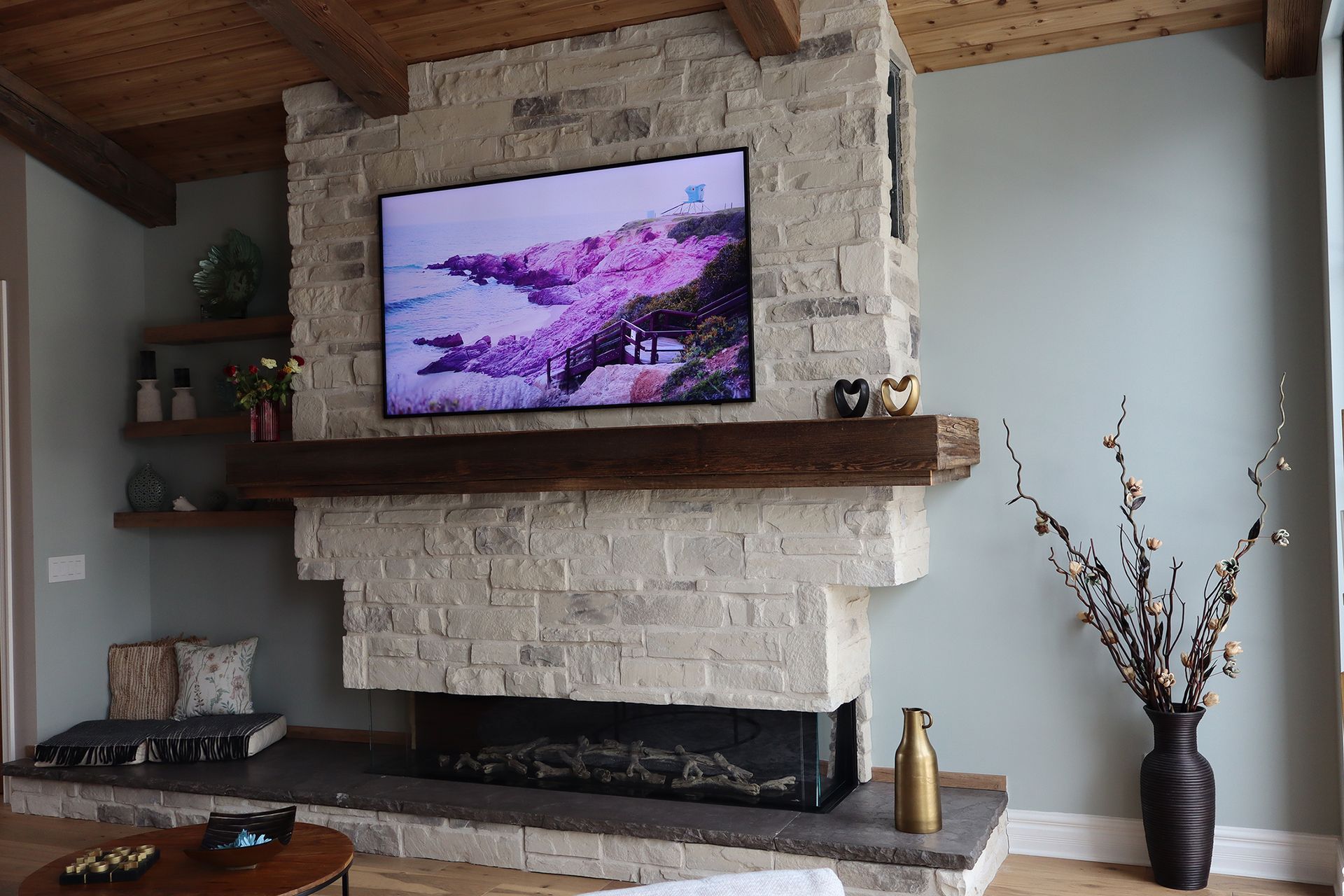 A living room with a fireplace and a flat screen tv