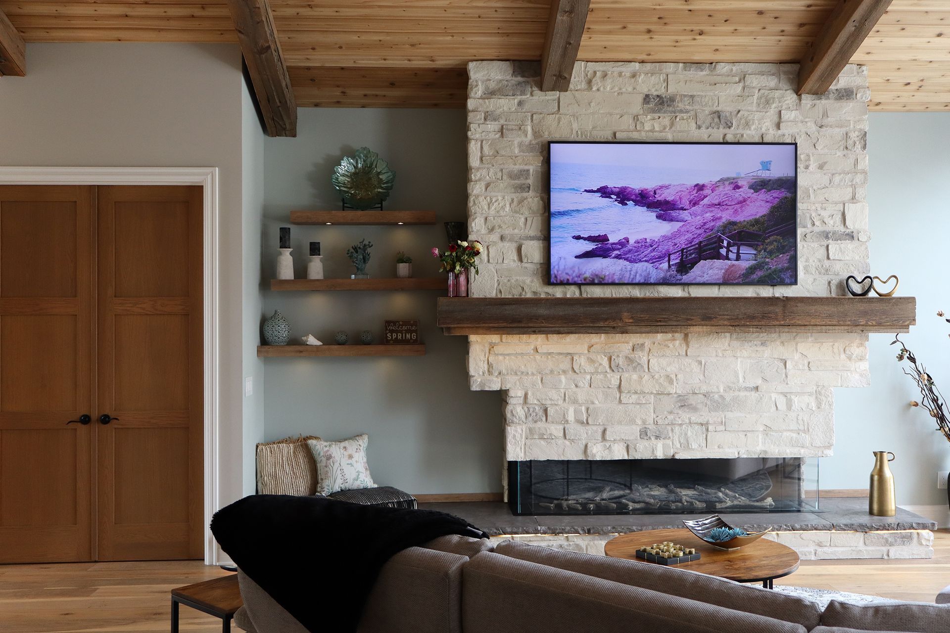 A living room with a fireplace and a flat screen tv above it.