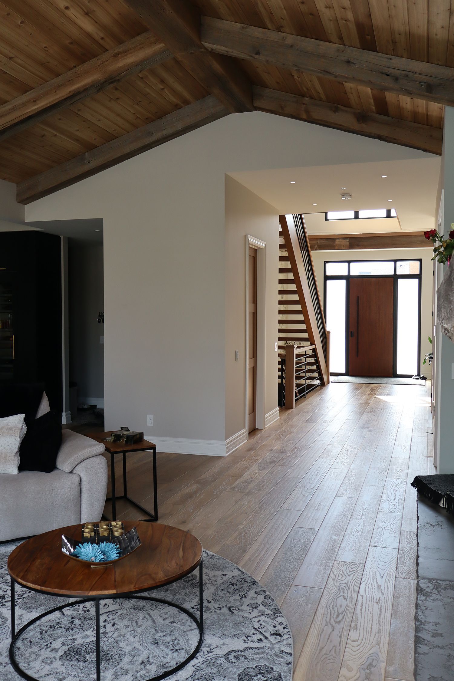 A living room with a couch , coffee table , and stairs.