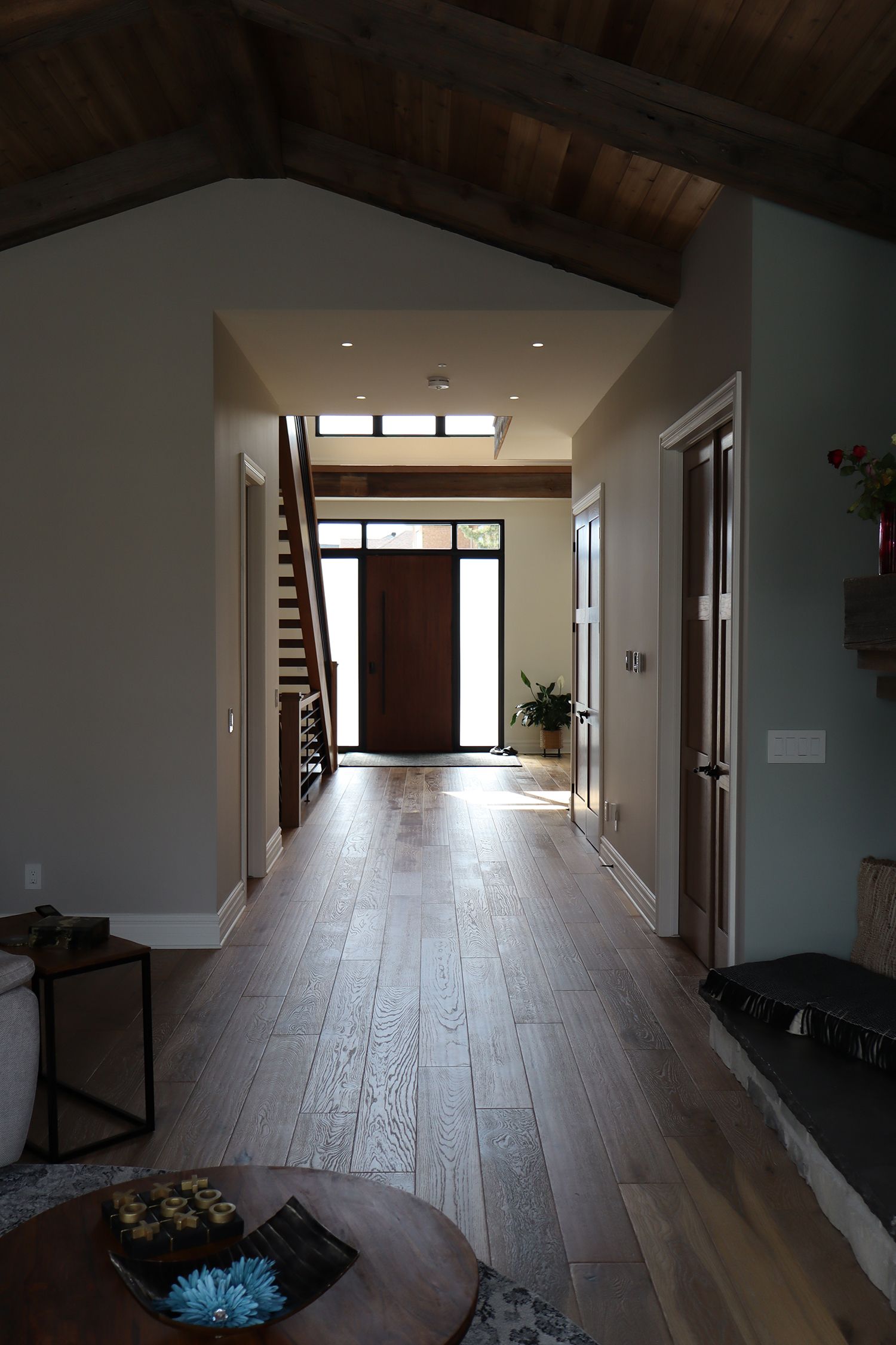 A hallway in a house with a wooden floor