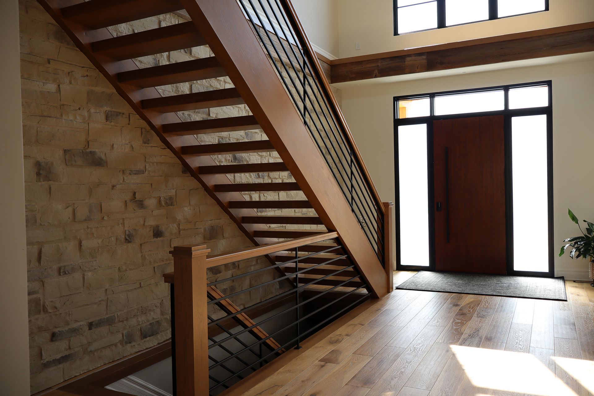 A wooden staircase leading up to a door in a house