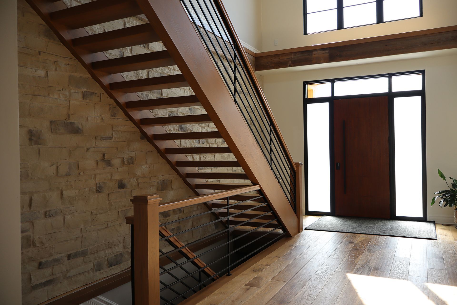 A wooden staircase leading up to a door in a house