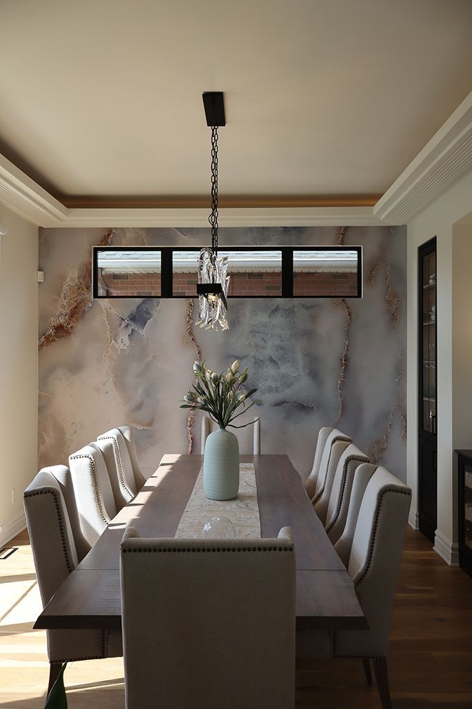 A dining room table with a vase of flowers on it