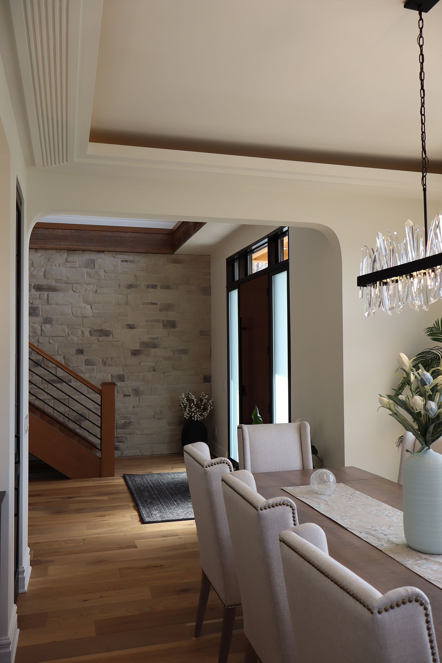 A dining room with a table and chairs and a chandelier.