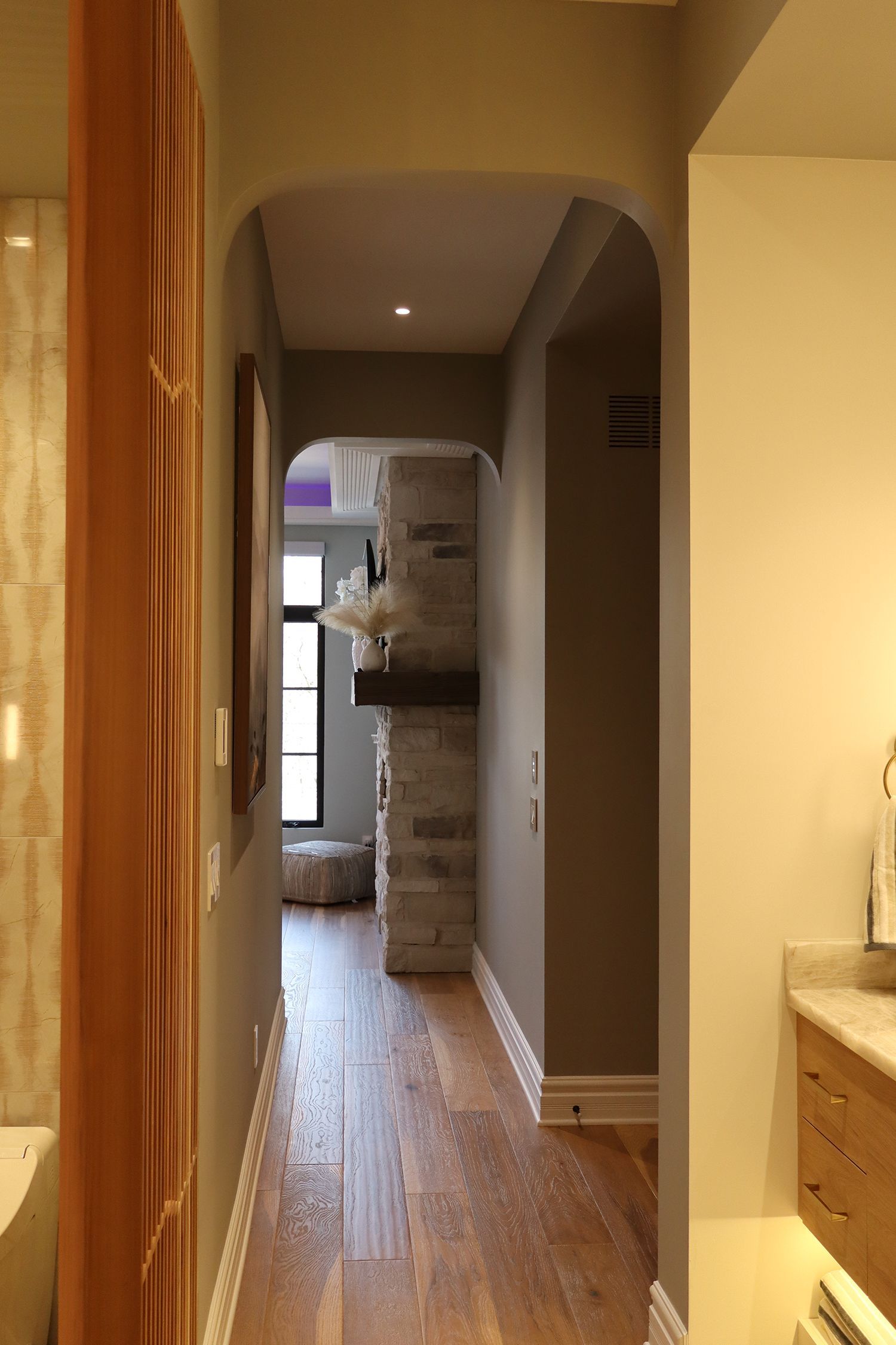 A hallway leading to a bathroom and a living room