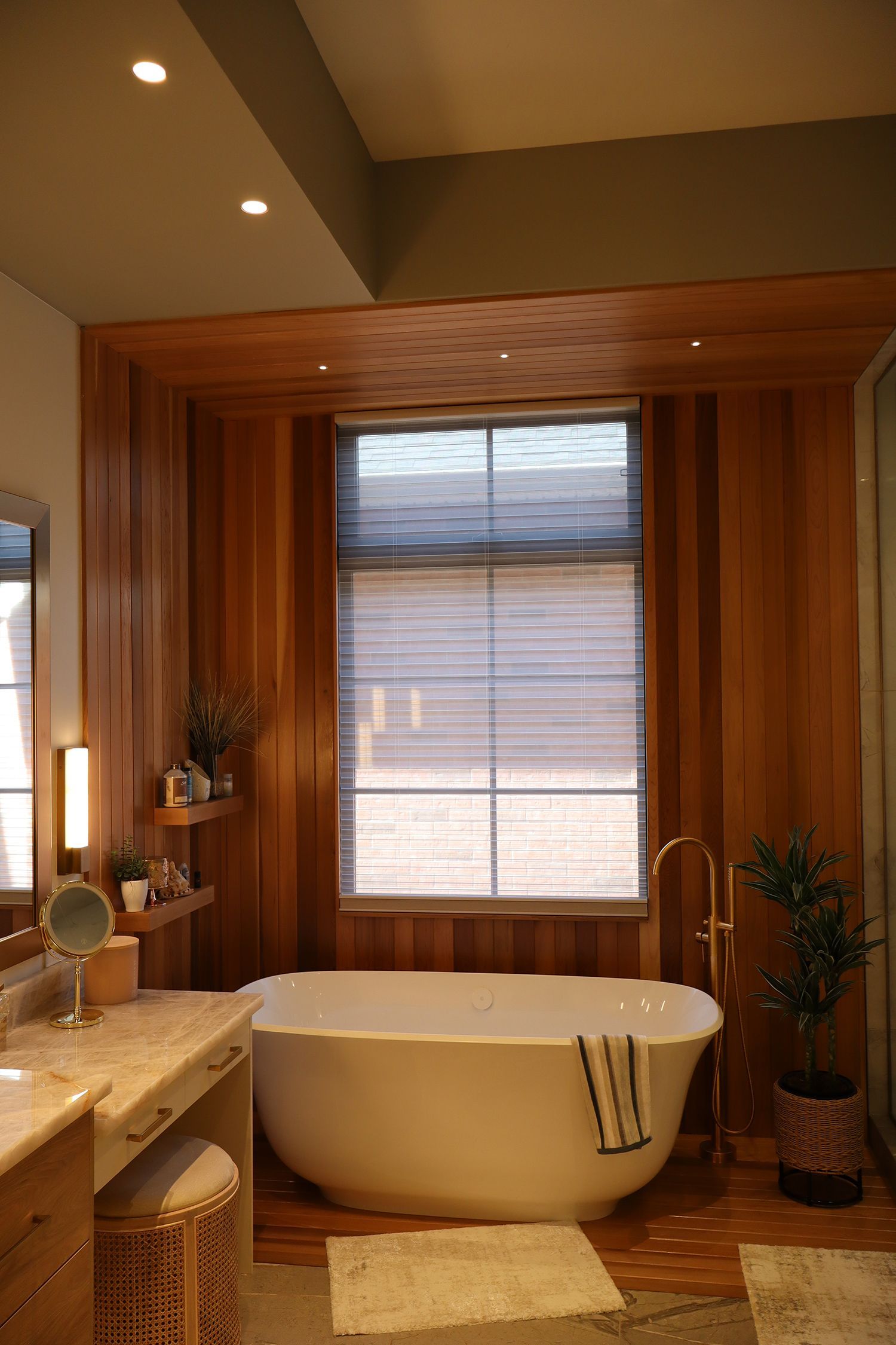A bathroom with a large tub and a window