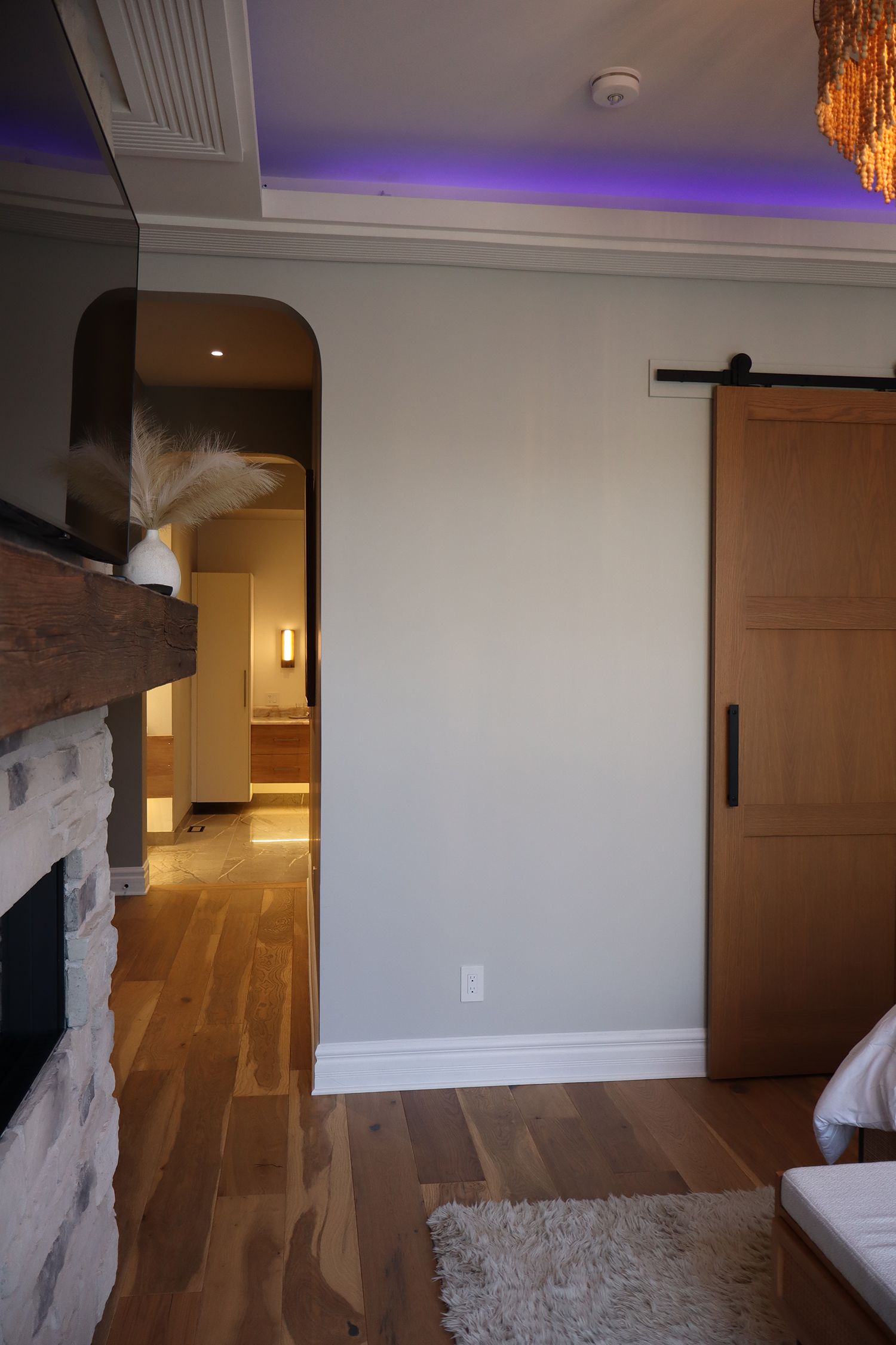 A living room with a fireplace and a sliding barn door