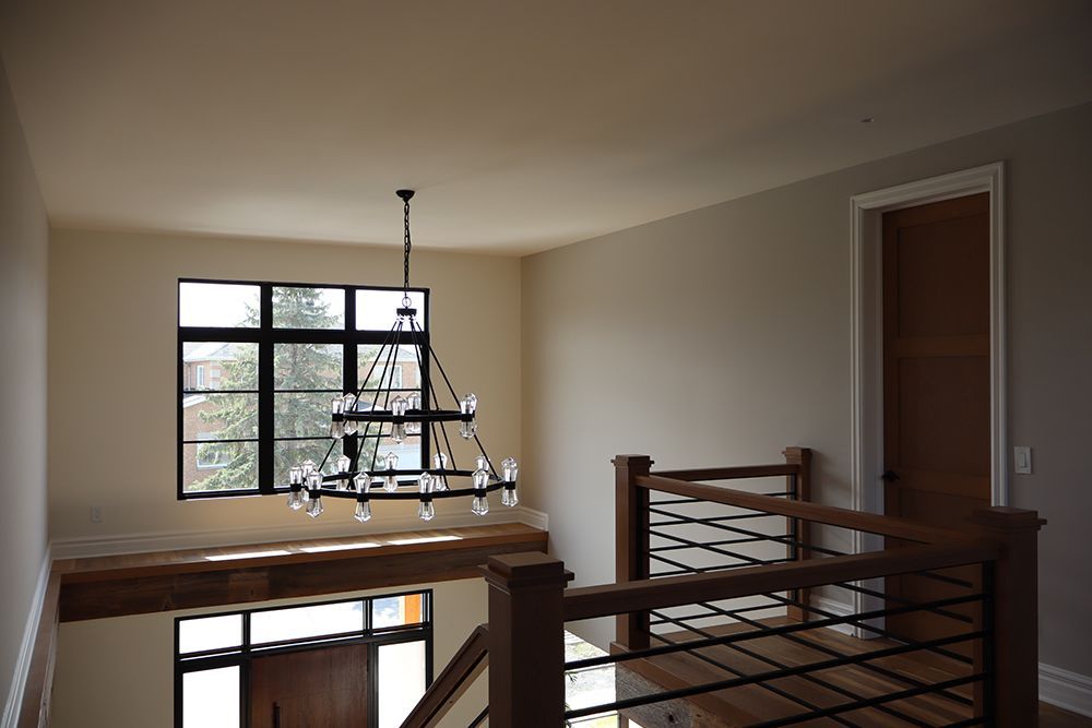 There is a chandelier hanging from the ceiling in the middle of the room.