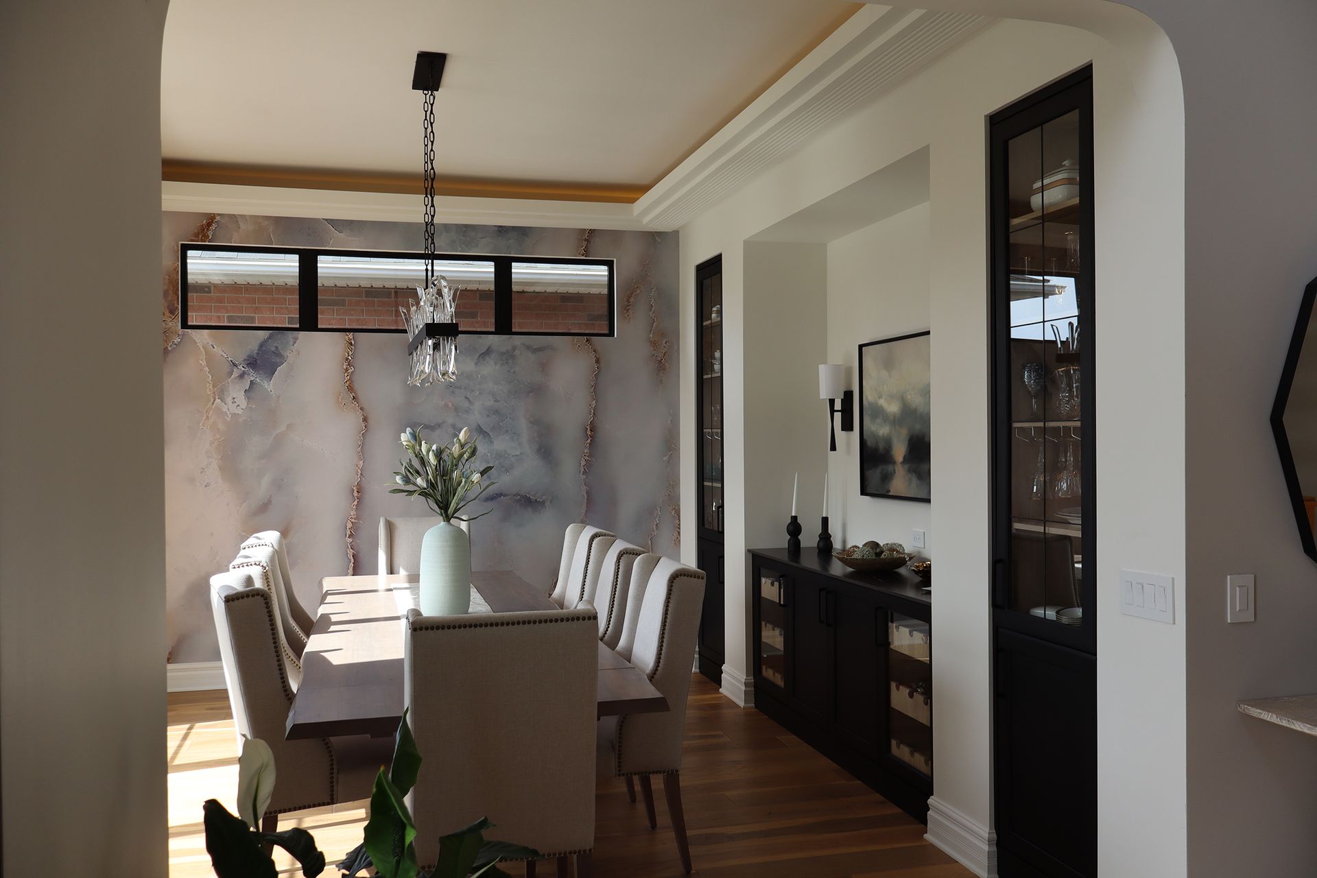 A dining room with a long table and chairs