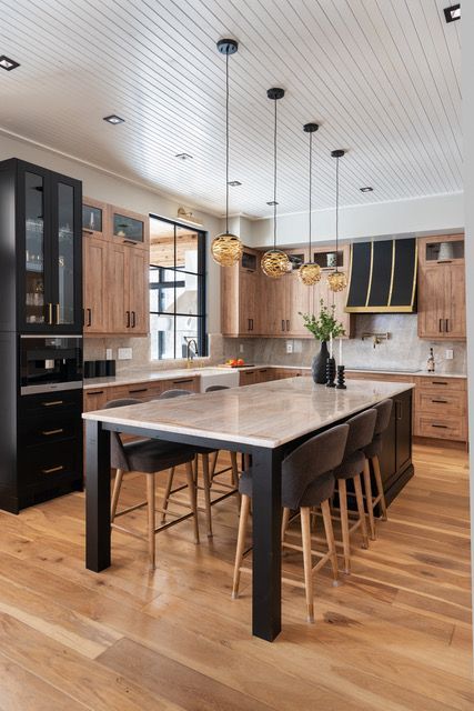 A kitchen with a table and chairs in it