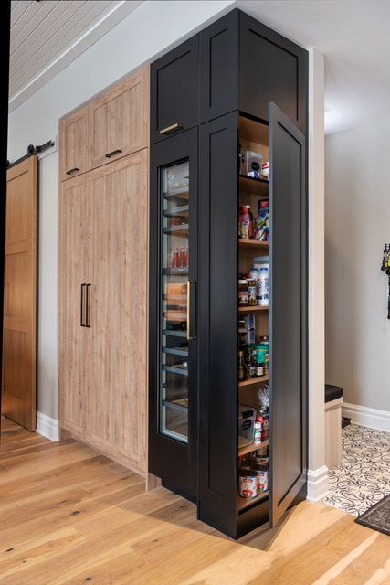 A pantry in a kitchen with a glass door