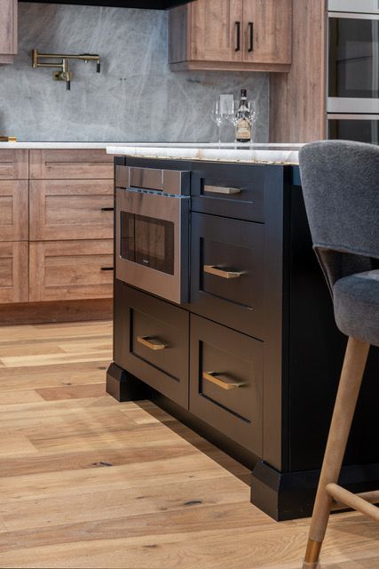 A kitchen with wooden cabinets and stainless steel appliances