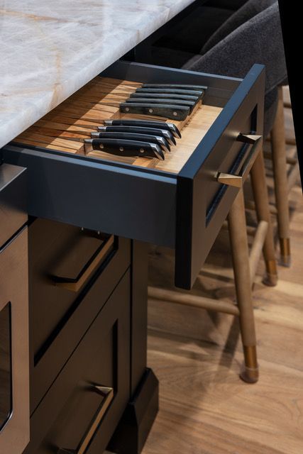 A drawer in a kitchen with knives in it