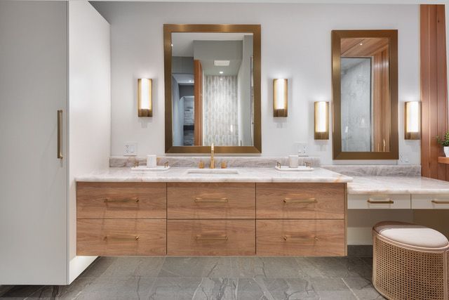 A bathroom with two sinks and two mirrors.