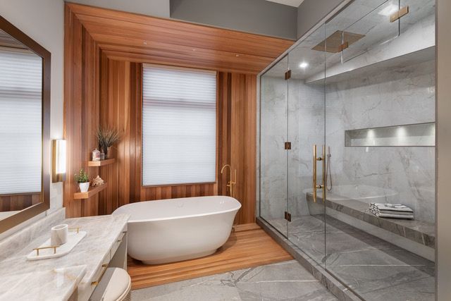 A bathroom with a bathtub and a walk in shower.