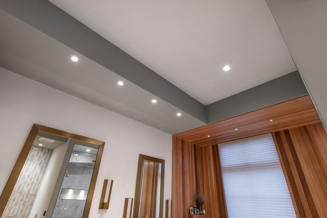 A room with a white ceiling and wooden walls