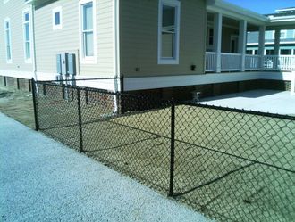 Brown Vinyl Coated Chain Link Fence And Dog — Elizabeth, NC — Albemarle Fence & Rail, Co.