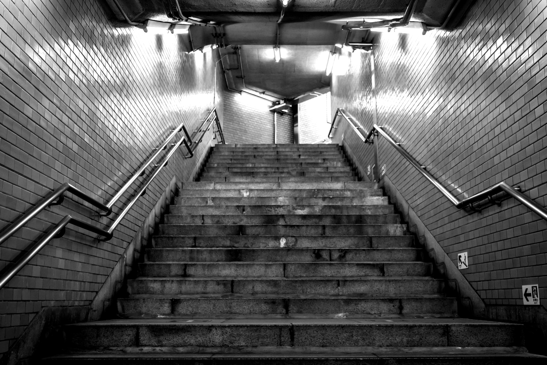 Breaking ocean wave, white foam against teal and dark blue water.