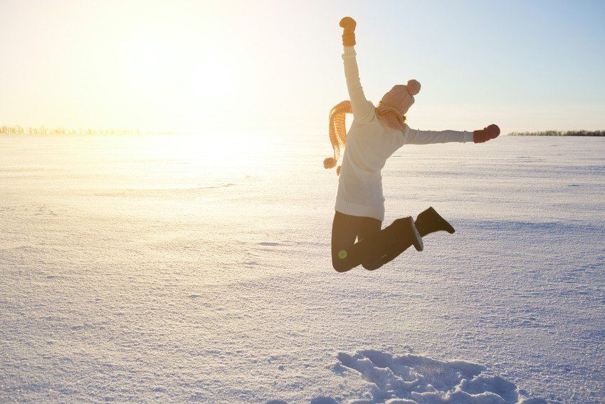 Happy girl with a red scarf on the winter background