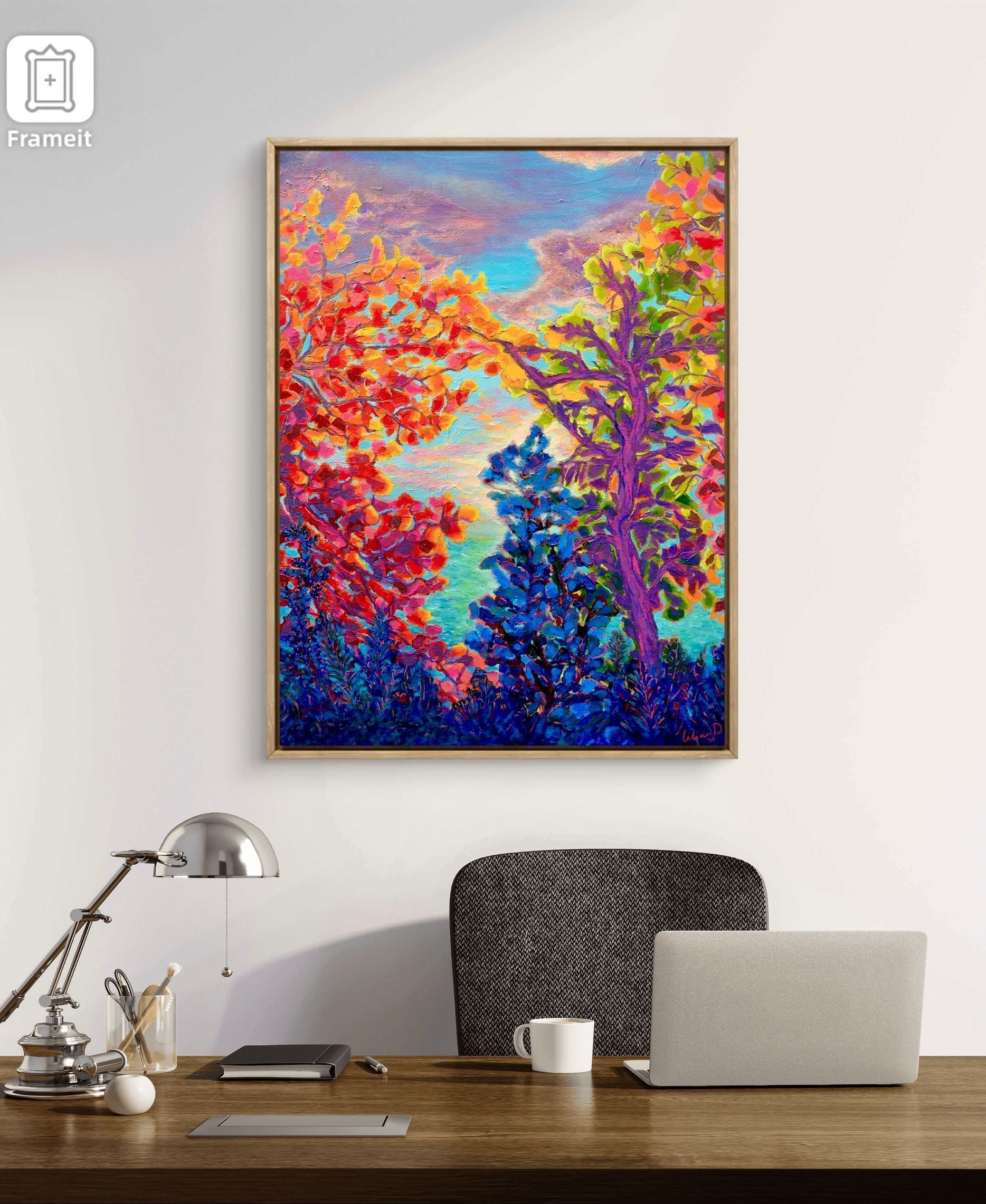 Een schilderij aan de muur van natuur boven een bureau in een kantoor.