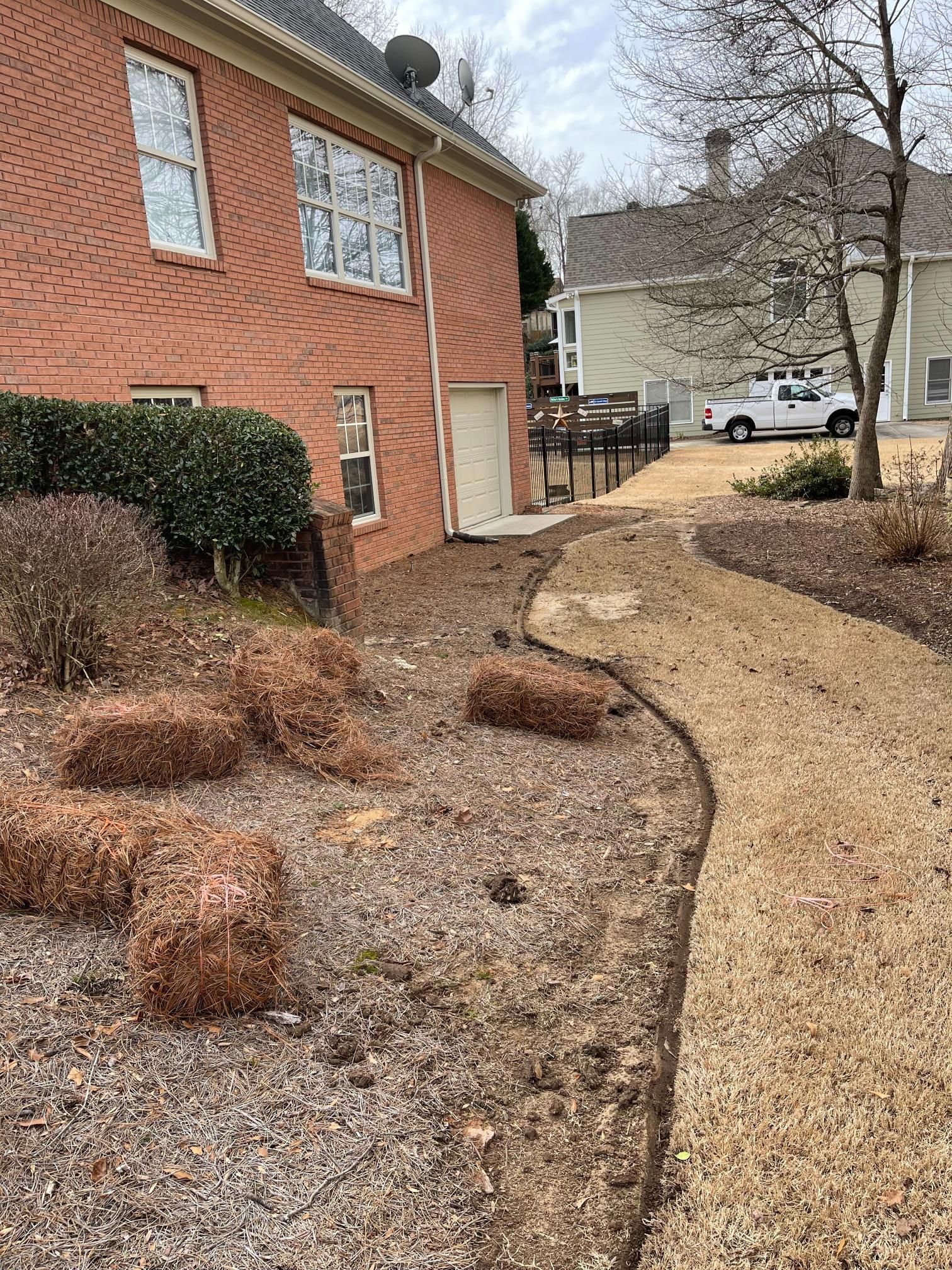 A brick house with a white truck parked in front of it.