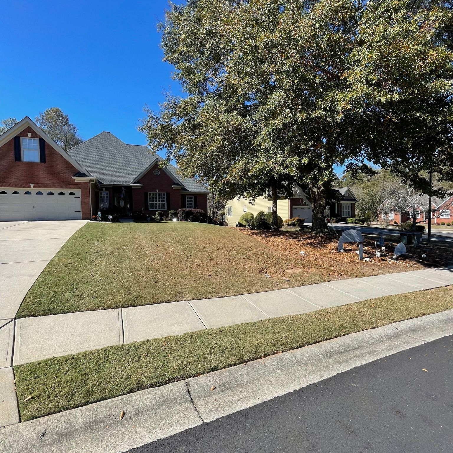 A brick house with a picnic table in front of it