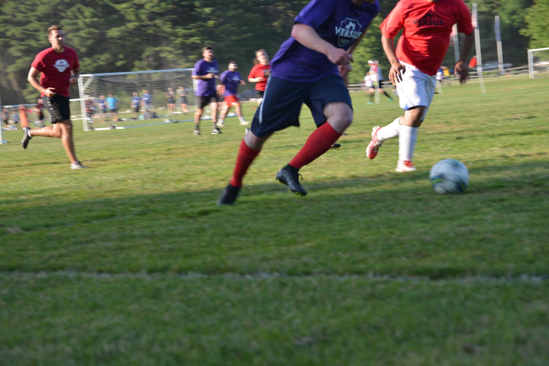 A group of people are playing soccer on a field.